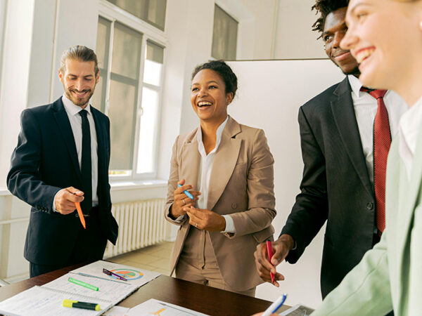 Professionals in a meeting, smiling and discussing.