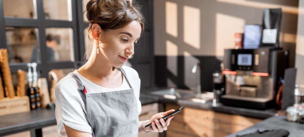 woman cafe apron phone